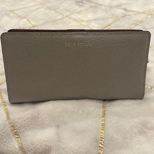 Grey Kate Spade slim 10 card wallet, burgundy inside. Excellent condition.